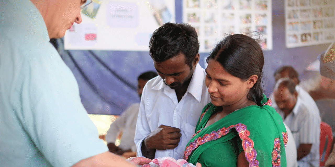 Jim dedicating baby during a vision trip.