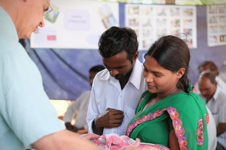Jim dedicating baby during a vision trip.