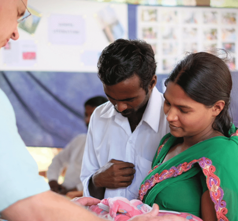 Jim dedicating baby during a vision trip.